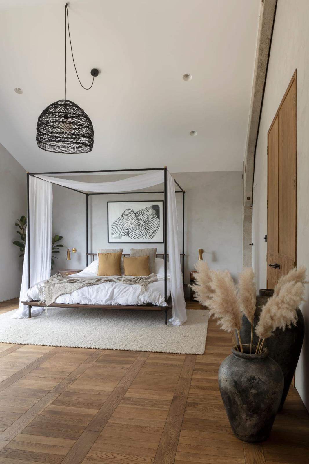 Patterned wood floor in a timber-framed bedroom